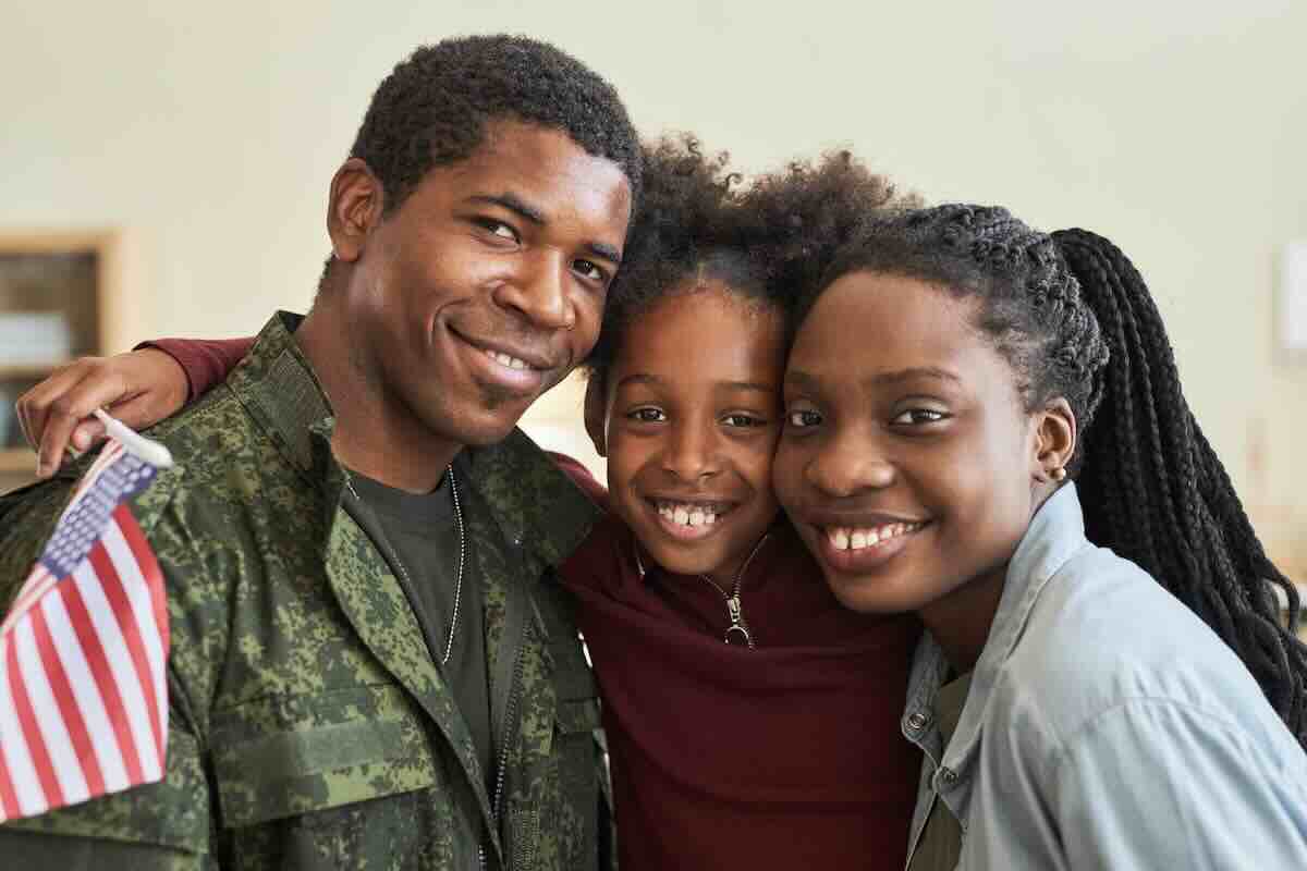 African American family with man in uniform, planning military moves together.