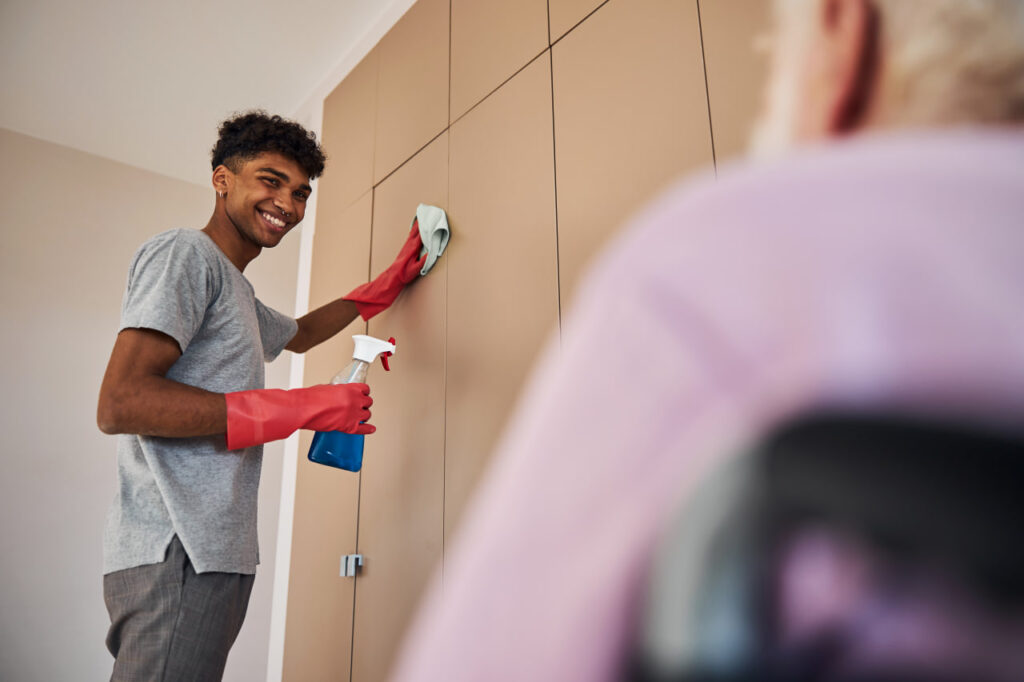 Young man preparing new home for move through cleaning and moving day prep.