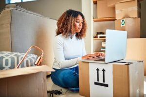 Woman with curly hair researching moving company prices looking for a moving estimate.