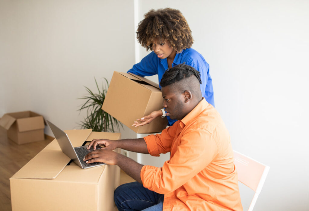 African American couple comparing a moving cost estimate with other moving company quotes.