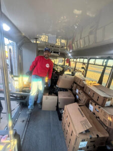 A bus loaded with food packed in boxes donated by Texas movers.