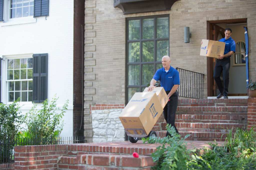 Image 4: Texas movers with Mayflower Moving Company labeling boxes.